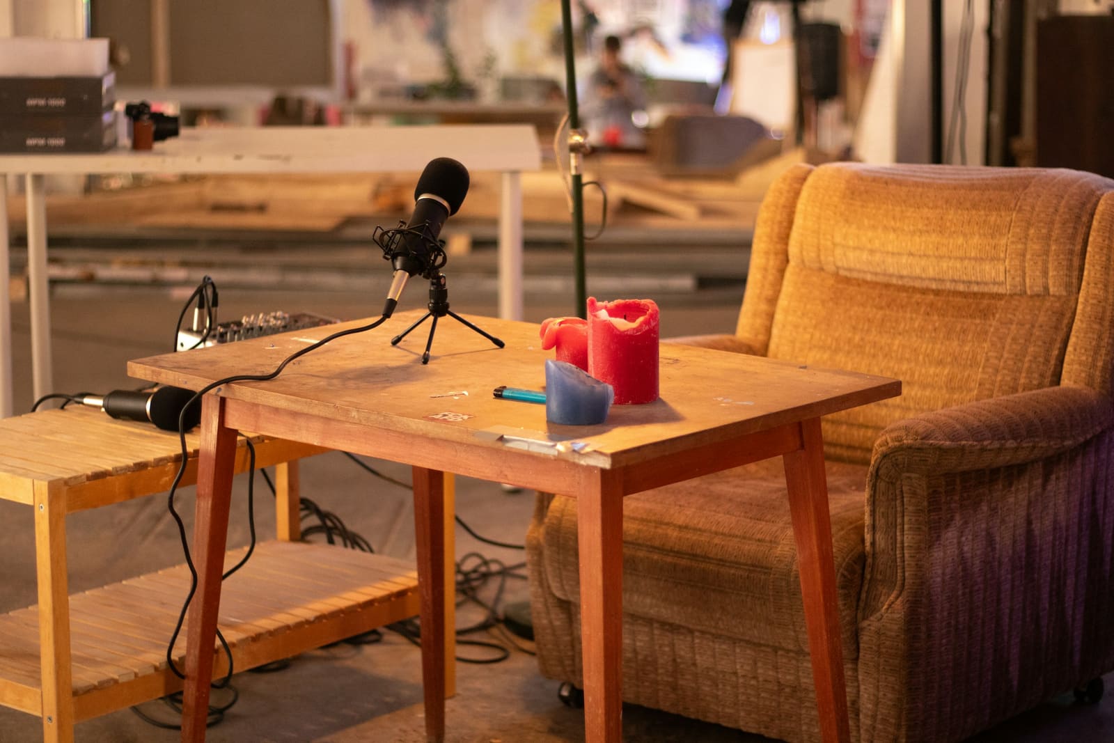 Studio microphone set up beside an armchair for a podcast recording