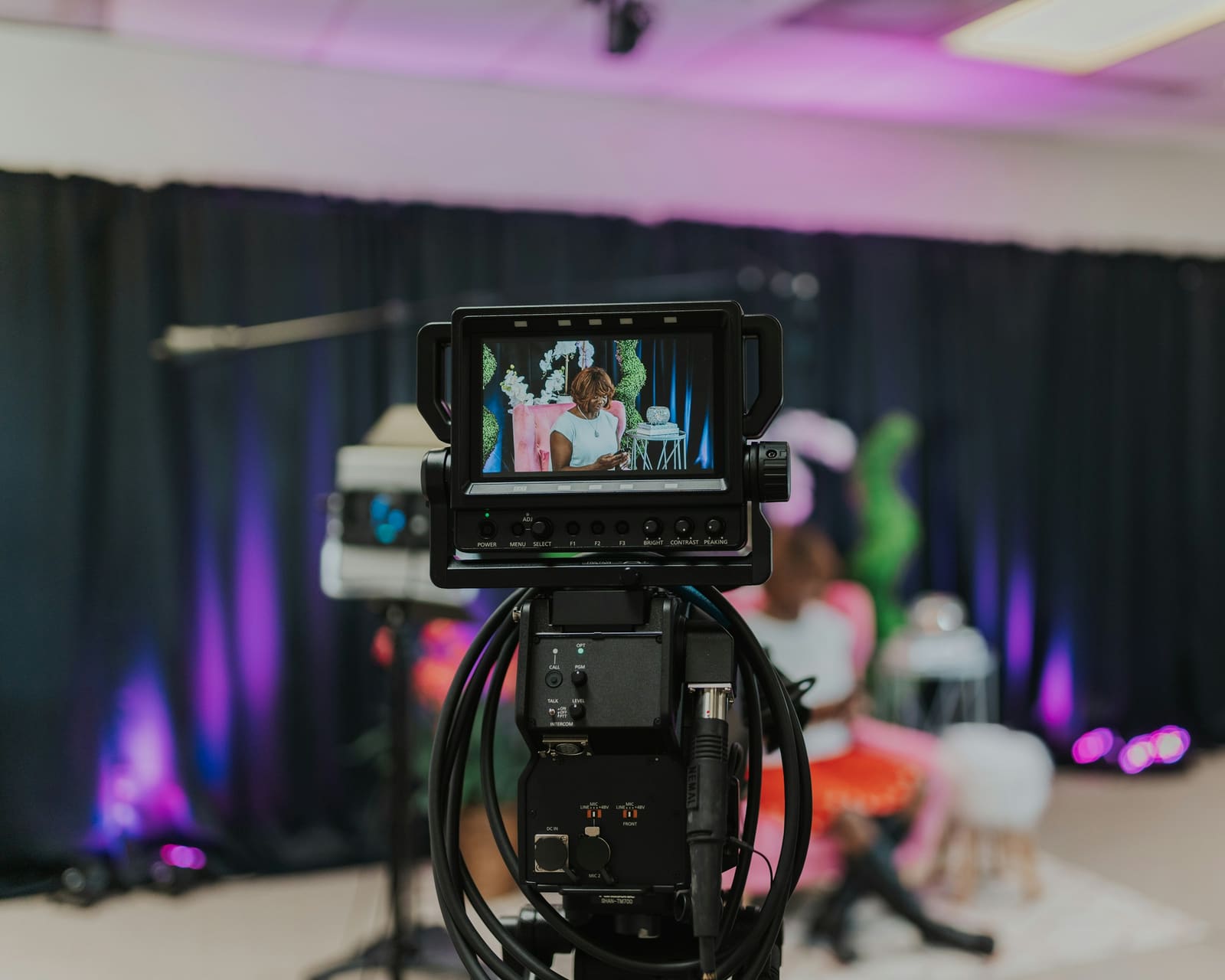 Video camera monitor framing a subject on a lit production set